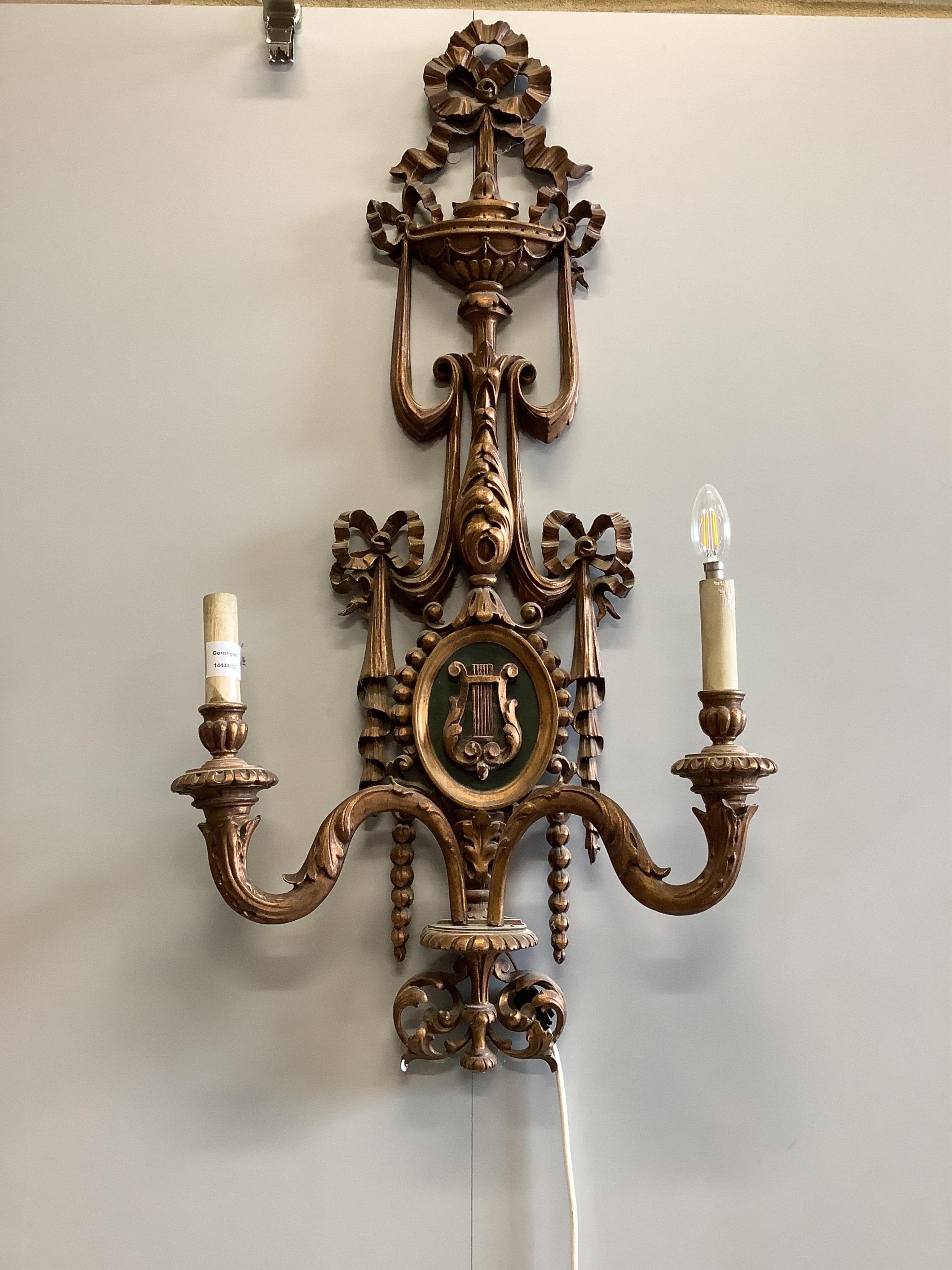 A pair of Louis XV style carved giltwood twin branch wall lights, height 110cm. Condition - fair